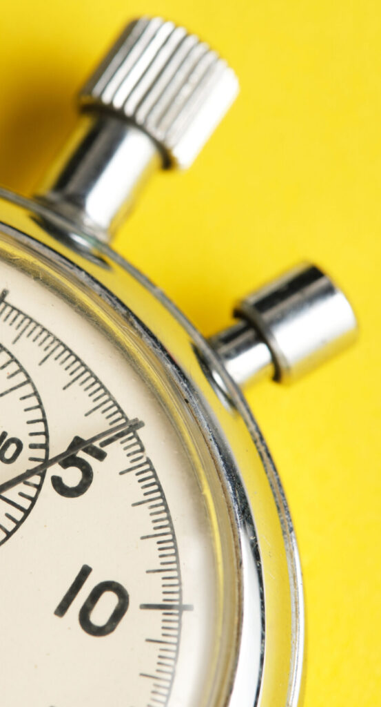 Mechanical stopwatch yellow background closeup